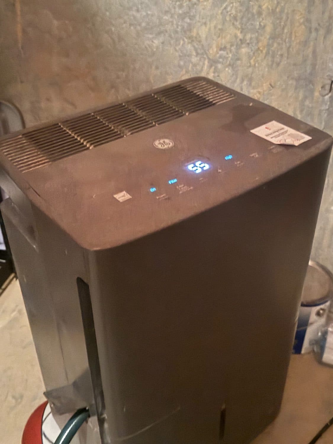 Freestanding dehumidifier running in an unfinished basement
